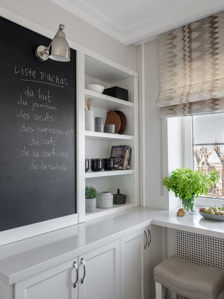 Foto de cocina contemporánea con armarios con paneles empotrados, puertas de armario blancas y encimeras blancas