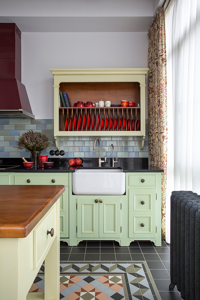 Inspiration for a farmhouse single-wall enclosed kitchen remodel in Moscow with a farmhouse sink, shaker cabinets, green cabinets, multicolored backsplash and an island