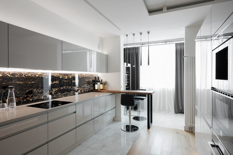 Inspiration for a contemporary kitchen in Moscow with flat-panel cabinets, grey cabinets, black splashback, a breakfast bar and white floors.
