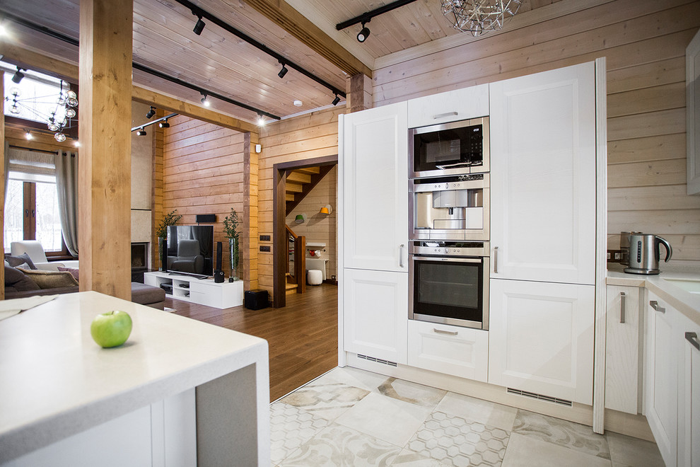 Foto di una cucina minimal di medie dimensioni con lavello sottopiano, ante con riquadro incassato, ante bianche e paraspruzzi bianco