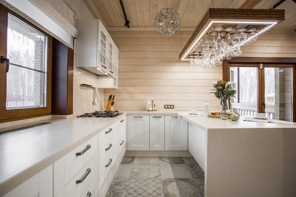 Foto di una cucina minimal di medie dimensioni con lavello sottopiano, ante con riquadro incassato, ante bianche e paraspruzzi bianco