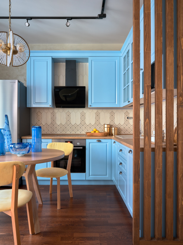 This is an example of a medium sized scandi l-shaped kitchen/diner in Moscow with a built-in sink, raised-panel cabinets, turquoise cabinets, laminate countertops, beige splashback, ceramic splashback, stainless steel appliances, dark hardwood flooring, brown floors and brown worktops.