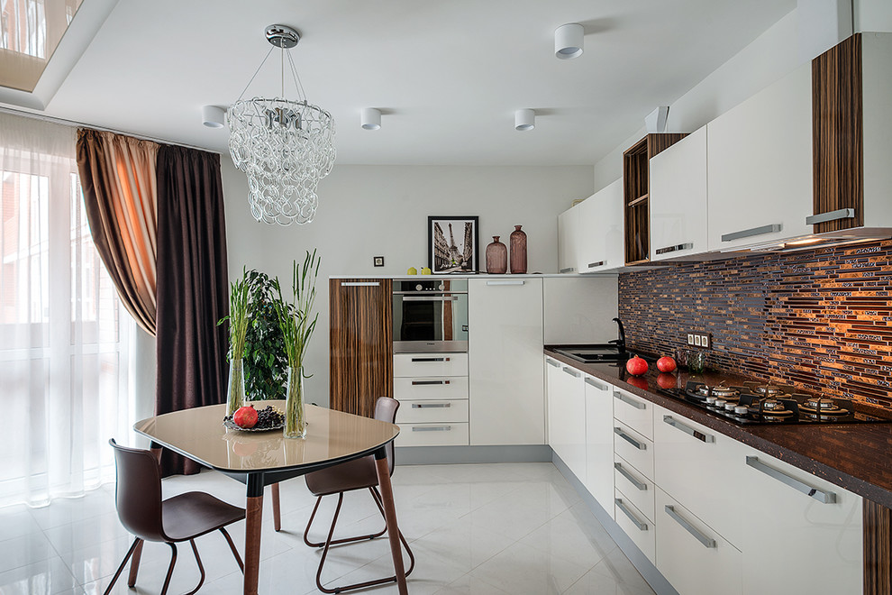 Design ideas for a contemporary l-shaped kitchen in Other with a built-in sink, flat-panel cabinets, white cabinets, brown splashback, no island, grey floors, matchstick tiled splashback and stainless steel appliances.
