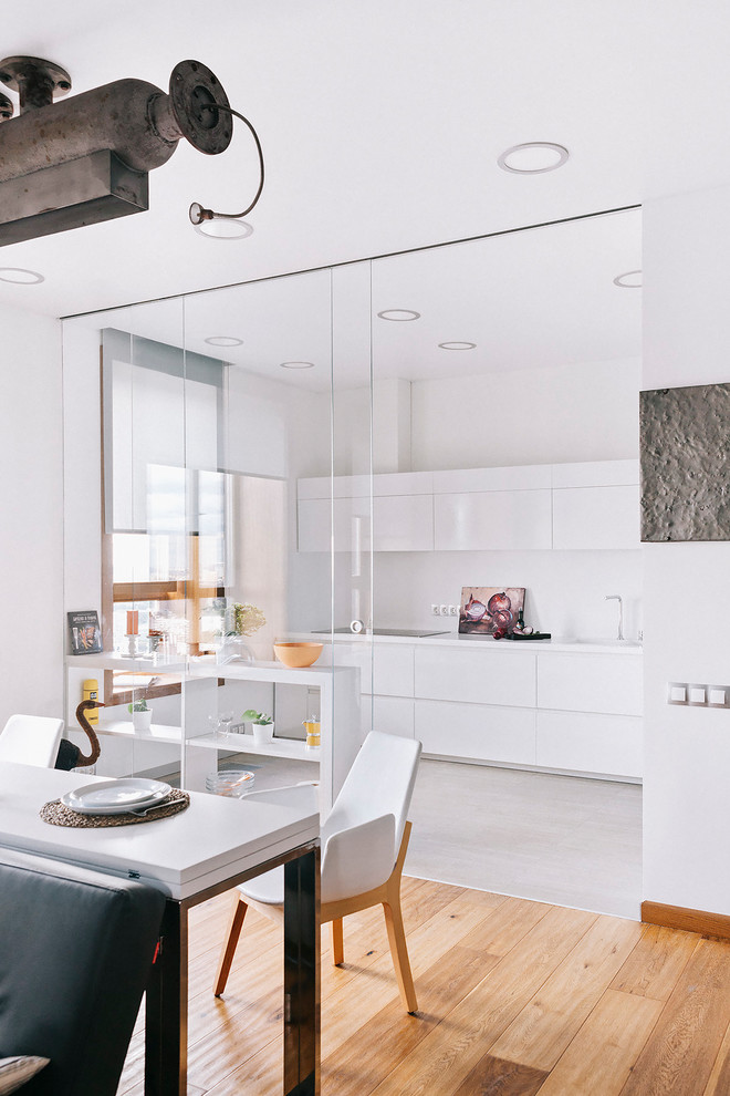 Inspiration for a contemporary single-wall kitchen in Moscow with flat-panel cabinets, white cabinets, white splashback, no island and grey floors.