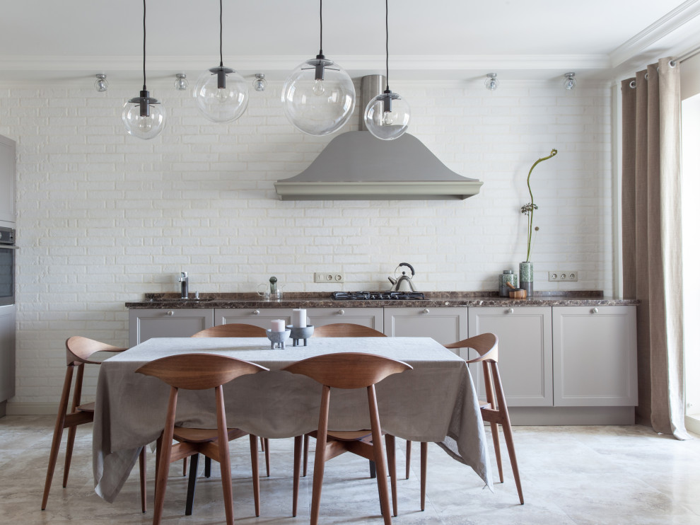 Design ideas for a scandi l-shaped kitchen/diner in Other with recessed-panel cabinets, grey cabinets, white splashback, brick splashback, no island, beige floors and brown worktops.