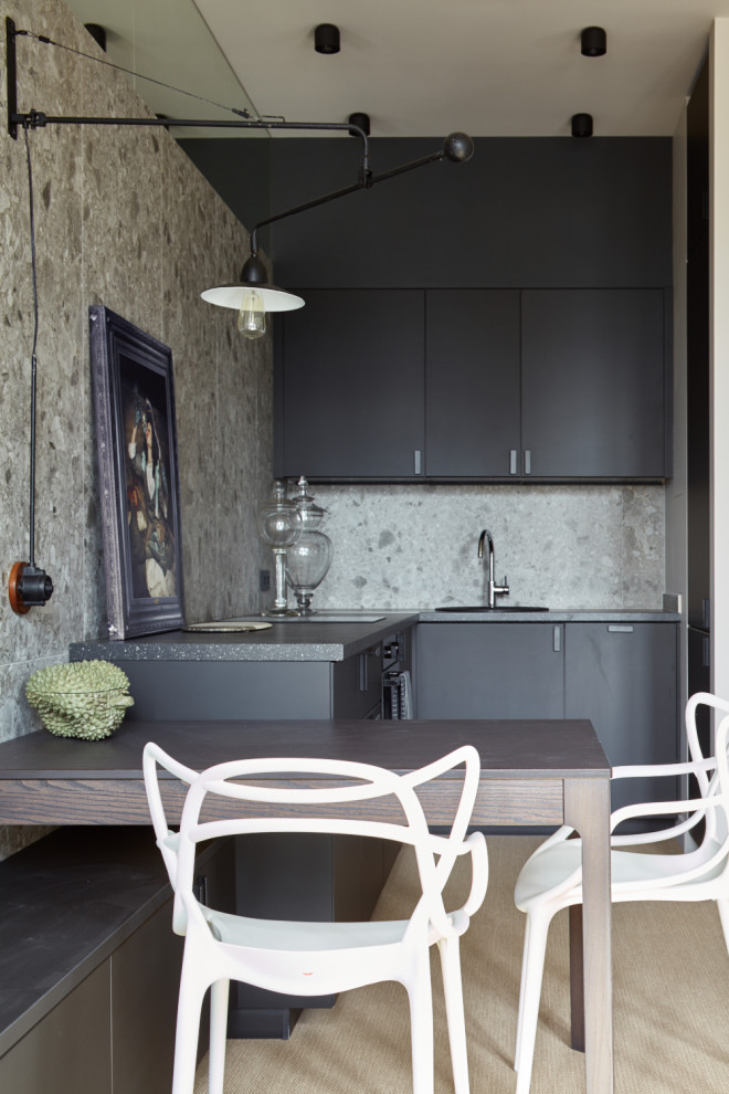 Photo of a small contemporary l-shaped kitchen/diner in Moscow with a built-in sink, flat-panel cabinets, grey cabinets, grey splashback, cement tile splashback, stainless steel appliances, a breakfast bar, beige floors and grey worktops.