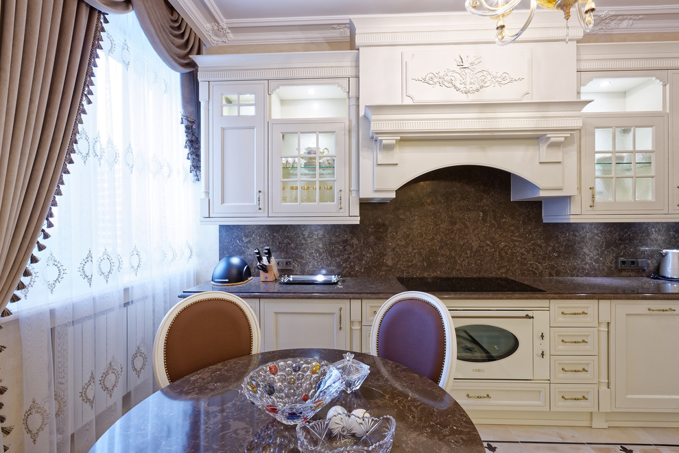 Medium sized classic l-shaped enclosed kitchen in Moscow with a built-in sink, raised-panel cabinets, white cabinets, engineered stone countertops, brown splashback, marble splashback, white appliances, ceramic flooring, no island, beige floors and brown worktops.
