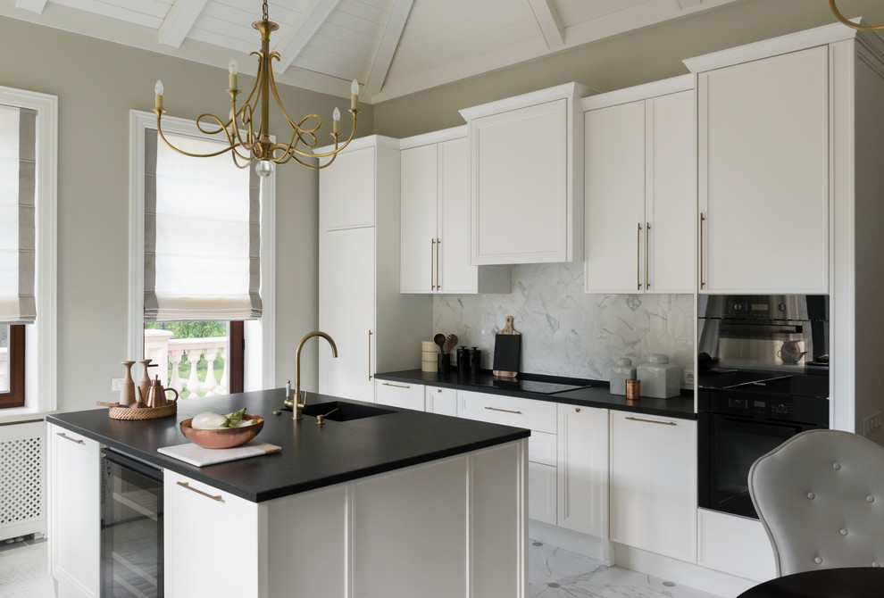 Classic galley kitchen in Moscow with white cabinets, white splashback, black appliances, marble flooring, an island, white floors, shaker cabinets and marble splashback.