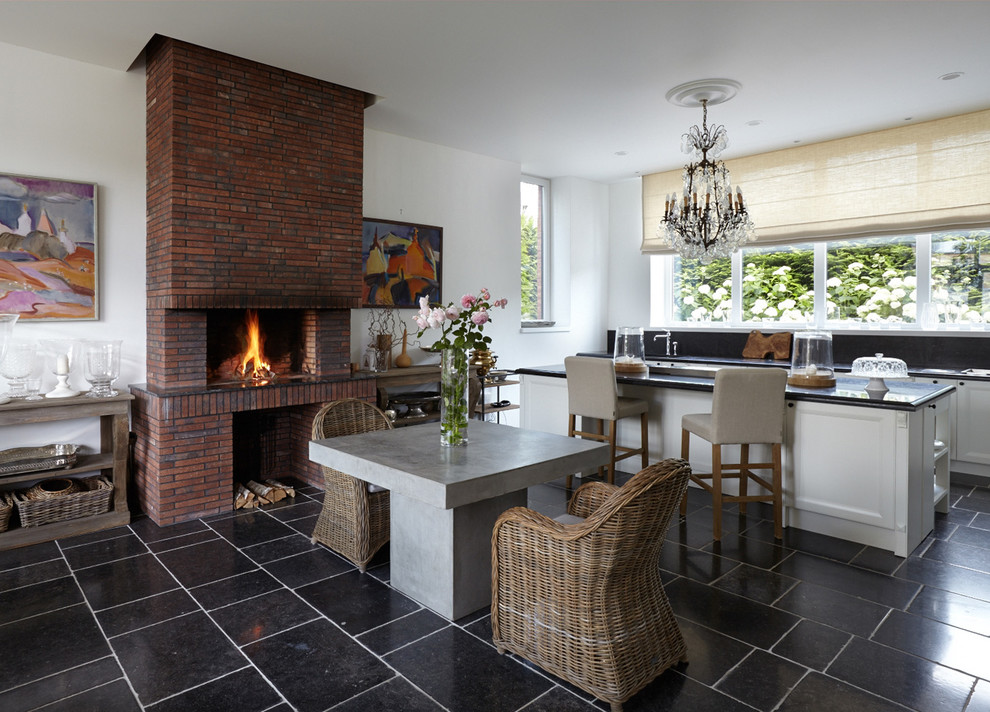 Свежая идея для дизайна: кухня-гостиная в современном стиле с островом и черным полом в частном доме - отличное фото интерьера