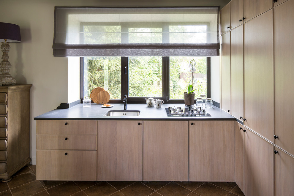 Photo of a medium sized contemporary u-shaped open plan kitchen in Moscow with a submerged sink, flat-panel cabinets, light wood cabinets, window splashback, granite worktops, integrated appliances and porcelain flooring.