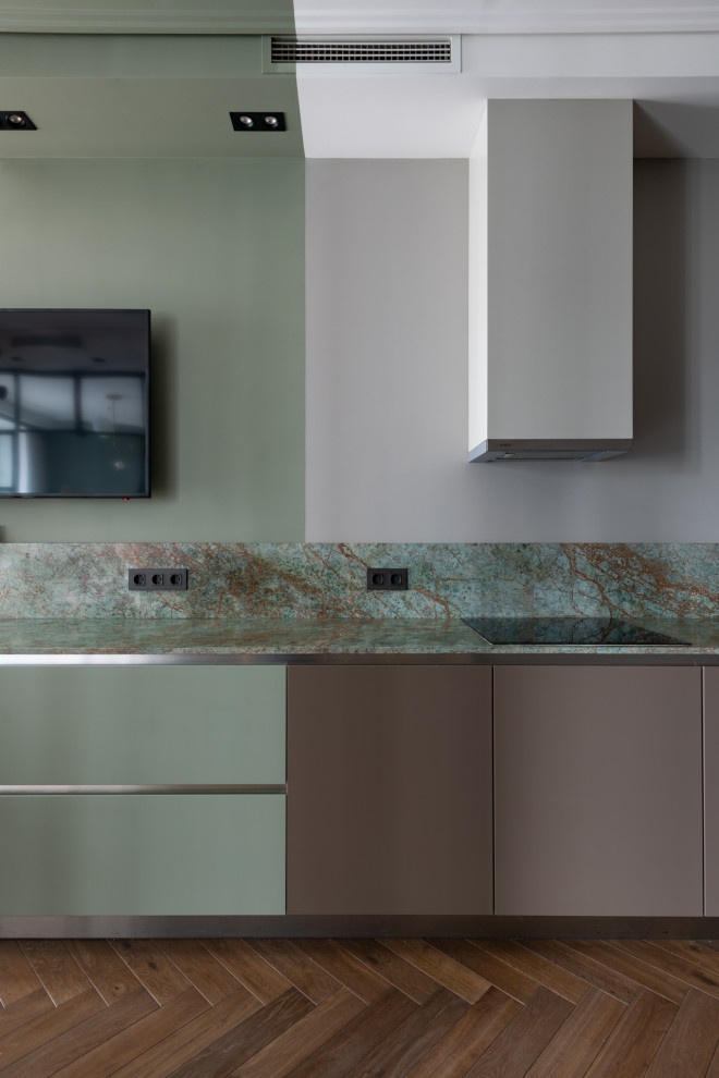 Inspiration for a contemporary brown floor kitchen remodel in Other with flat-panel cabinets, green cabinets, green backsplash and green countertops