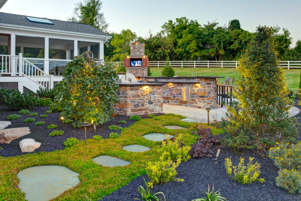 Photo of a large contemporary full sun backyard stone landscaping in Baltimore.