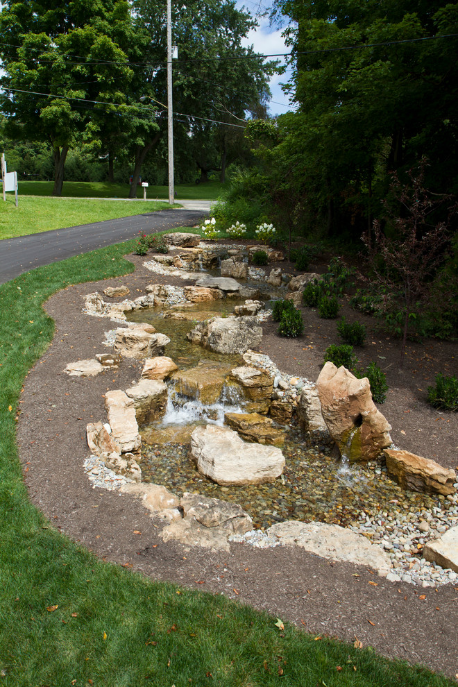 Design ideas for a contemporary garden in Cleveland with a water feature.