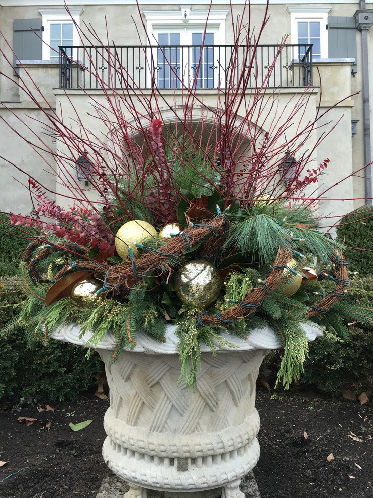 This is an example of a traditional front formal garden for winter in New York with a potted garden.