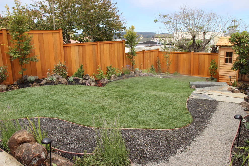 Photo of a large contemporary partial sun backyard gravel landscaping in San Francisco.