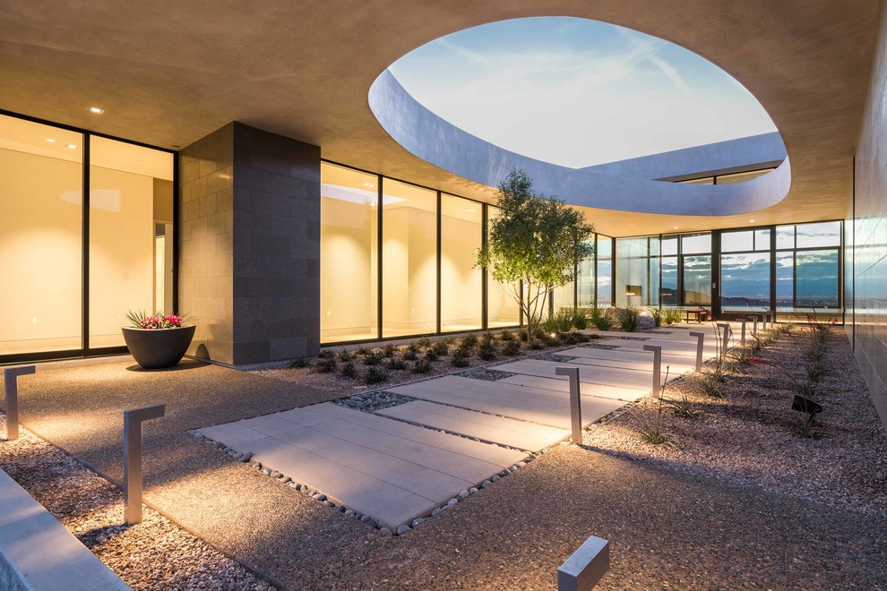 Design ideas for a contemporary front yard partial sun xeriscape in Las Vegas with a garden path and gravel.