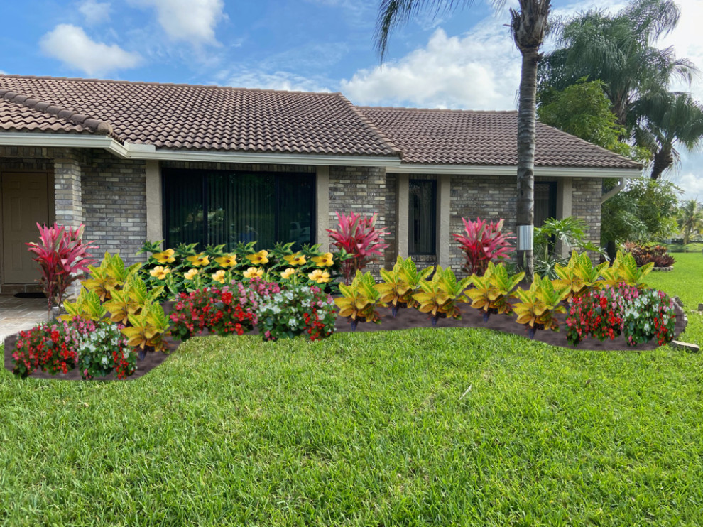 Photo of a large tropical full sun backyard brick landscaping in Miami.