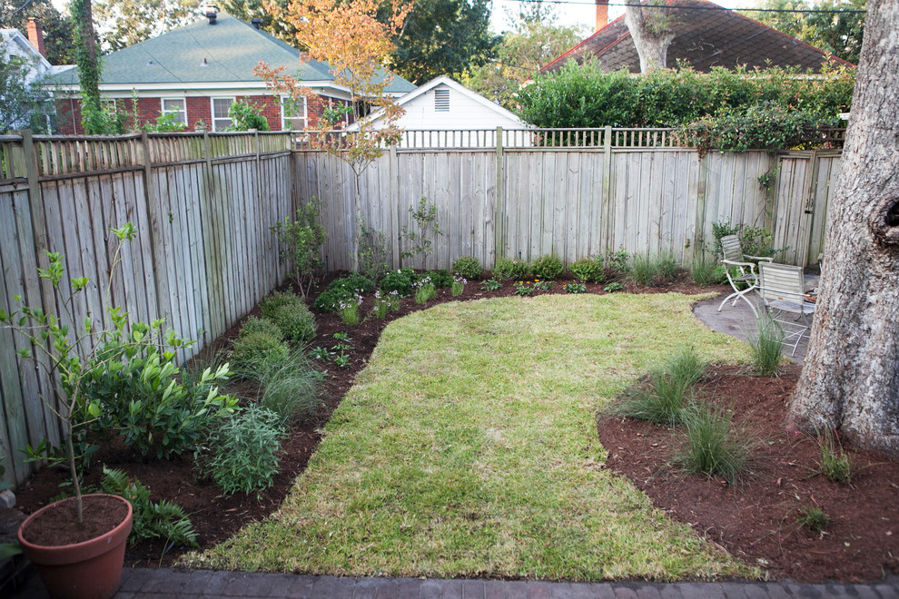 Photo of a mid-sized eclectic shade backyard landscaping in Atlanta.