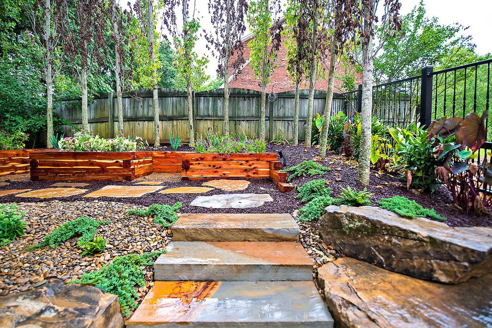 Inspiration for a mid-sized traditional full sun backyard stone formal garden in Nashville for spring.
