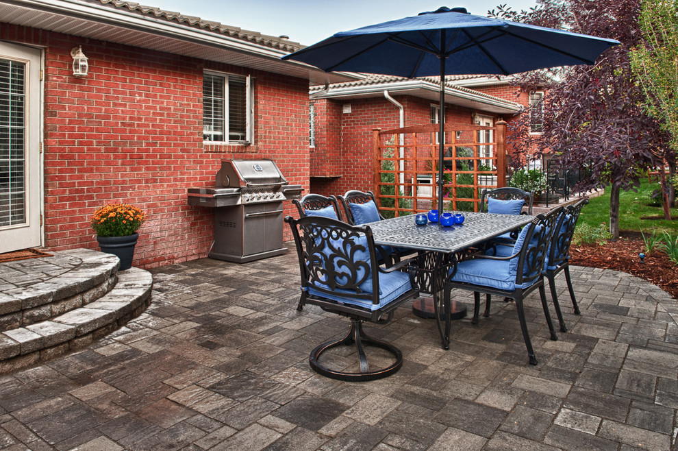 Patio - mid-sized traditional backyard brick patio idea in Calgary