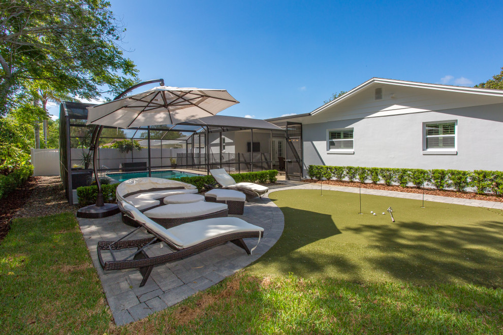 Mittelgroßer Retro Garten hinter dem Haus mit Sportplatz, Rasenkanten, direkter Sonneneinstrahlung und Pflastersteinen in Orlando