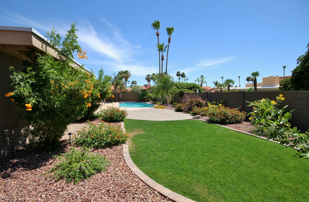 Design ideas for a medium sized mediterranean back full sun garden for spring in Phoenix with brick paving.