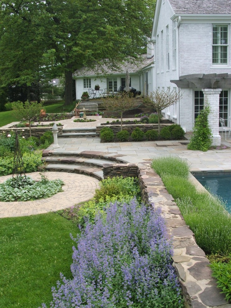 Inspiration for a traditional backyard stone landscaping in Chicago.