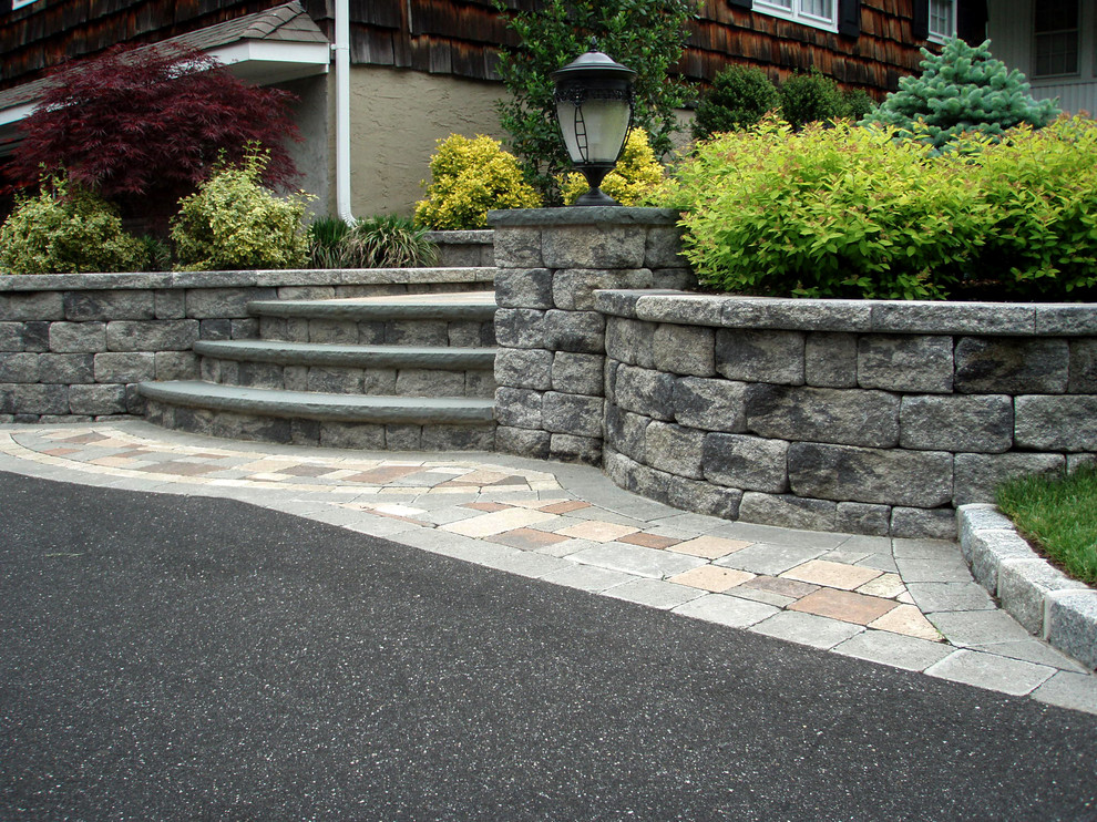 Design ideas for a classic front garden in New York with a retaining wall and concrete paving.