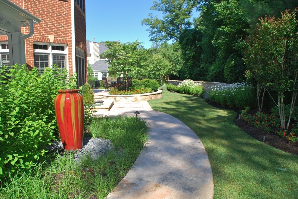 Medium sized classic back formal full sun garden for summer in DC Metro with a vegetable patch and natural stone paving.