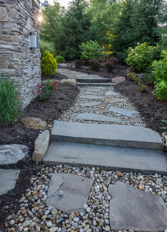 Photo of a medium sized classic side formal partial sun garden for summer in Cleveland with a garden path and gravel.