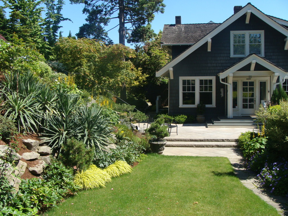 Photo of a craftsman full sun hillside landscaping in Seattle.