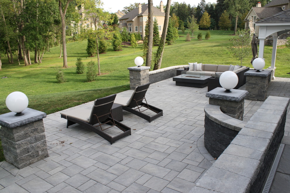 This is an example of a large modern full sun backyard concrete paver landscaping in Philadelphia.