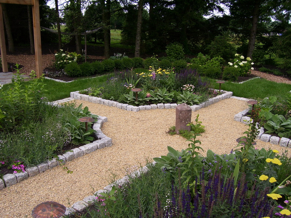 This is an example of a farmhouse backyard gravel landscaping in Philadelphia.