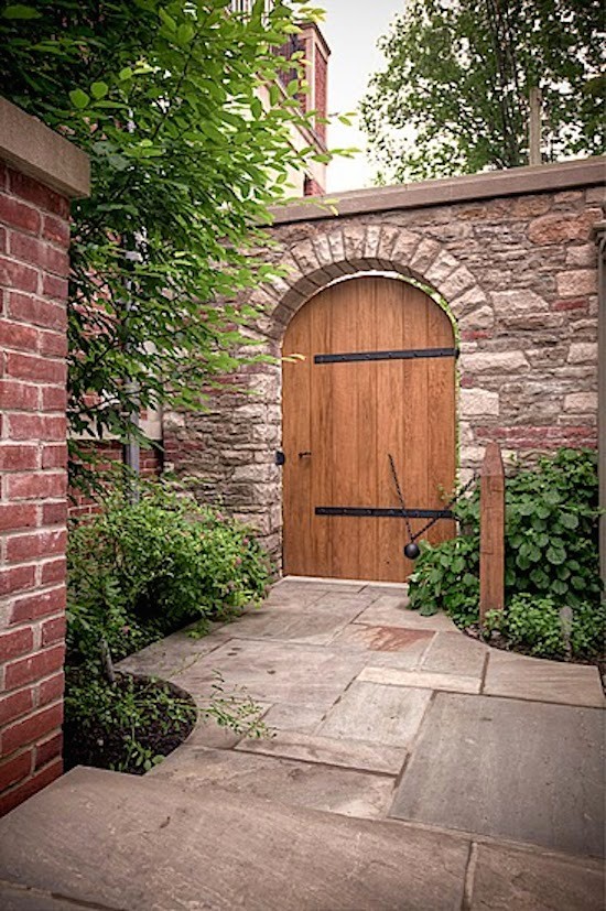 Inspiration for a large traditional backyard brick garden path in Toronto.