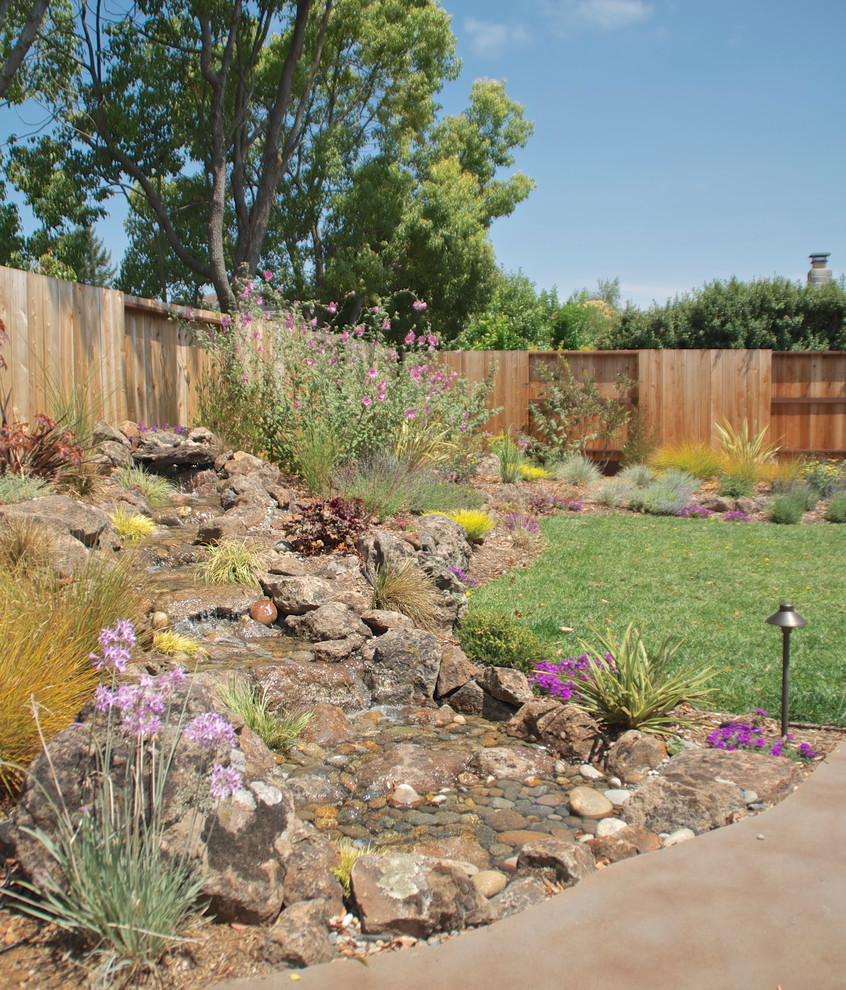 Photo of a large traditional full sun and drought-tolerant backyard concrete paver landscaping in San Francisco.