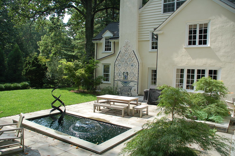 This is an example of a traditional backyard stone water fountain landscape in Philadelphia.