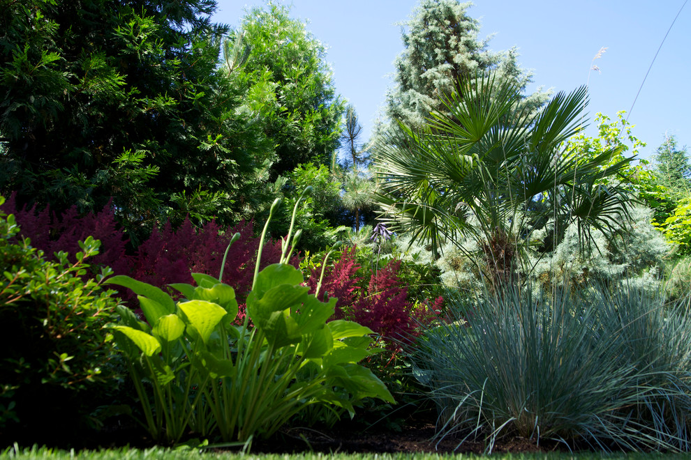 Photo of an expansive mediterranean front driveway partial sun garden in Portland.