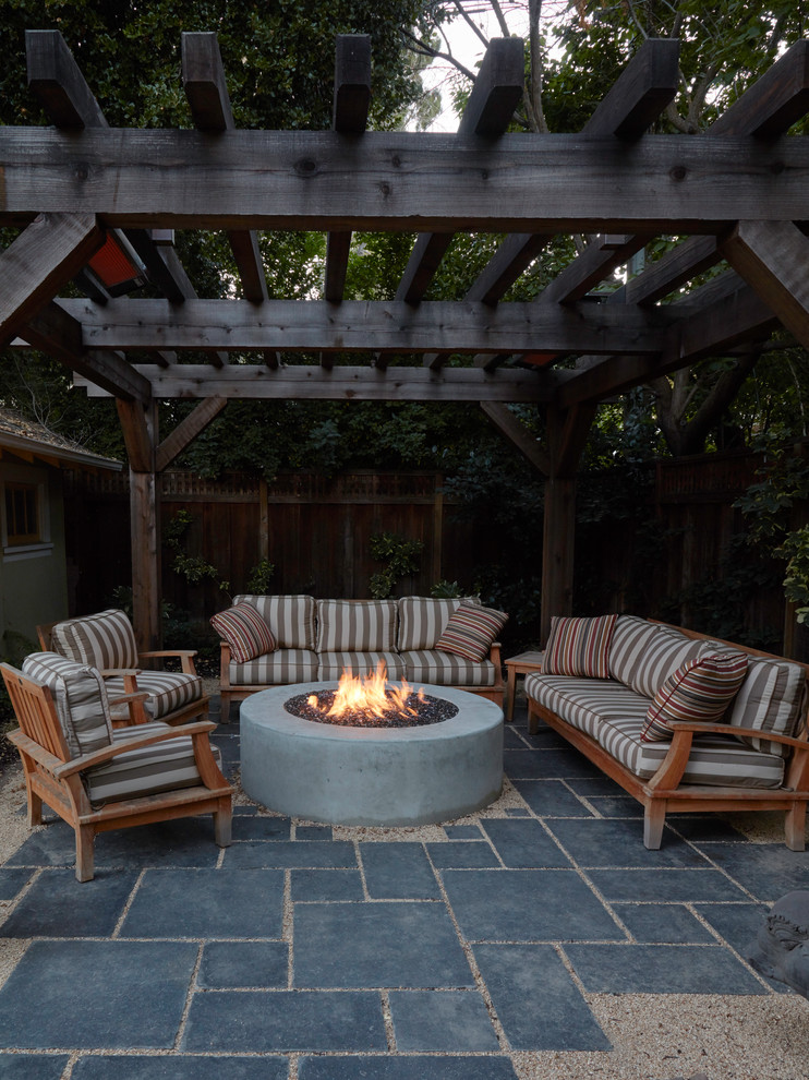 Ejemplo de patio de estilo americano pequeño en patio trasero con adoquines de piedra natural y brasero