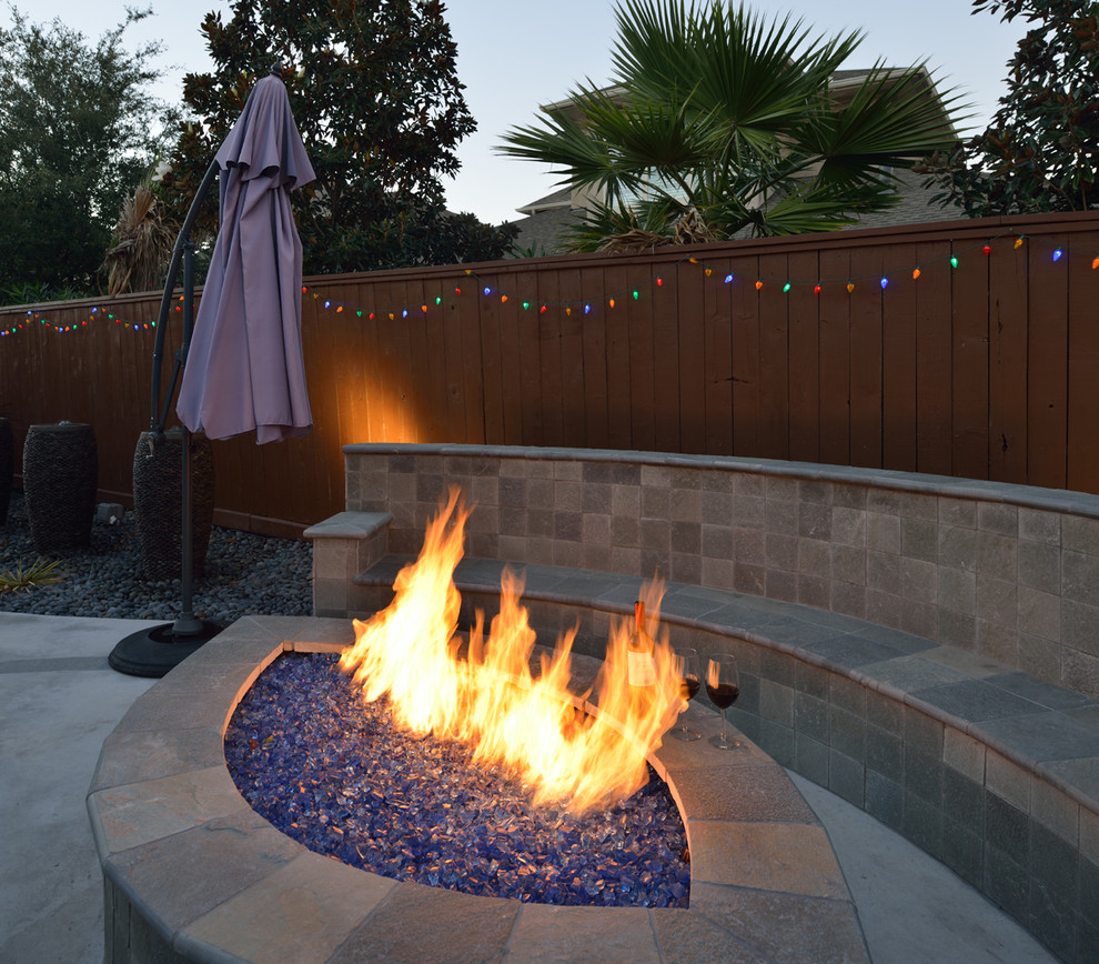 Medium sized classic back partial sun garden in Houston with an outdoor sport court, a fire feature and concrete paving.