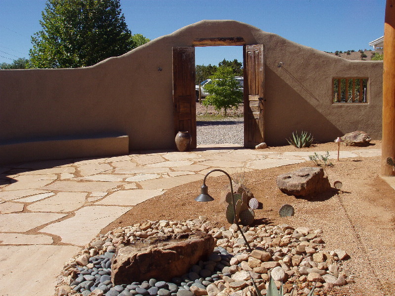 Inspiration for a mid-sized southwestern full sun backyard stone landscaping in Albuquerque.