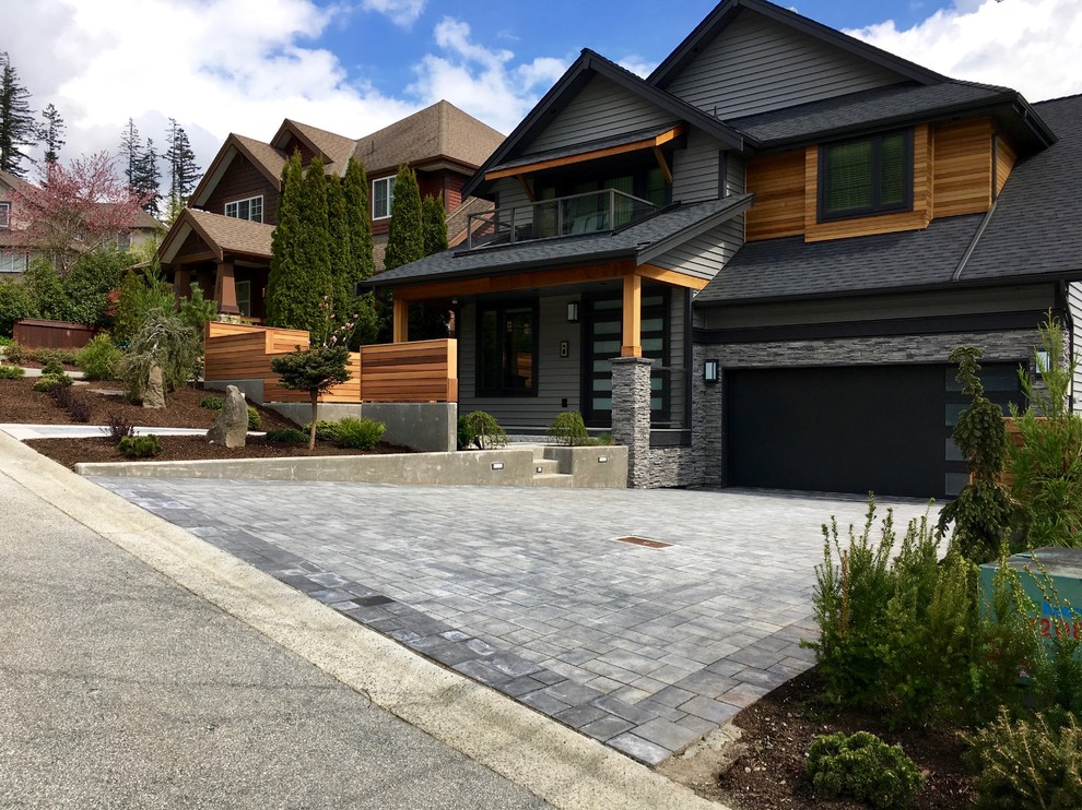 Design ideas for a large modern front driveway garden in Vancouver with concrete paving.
