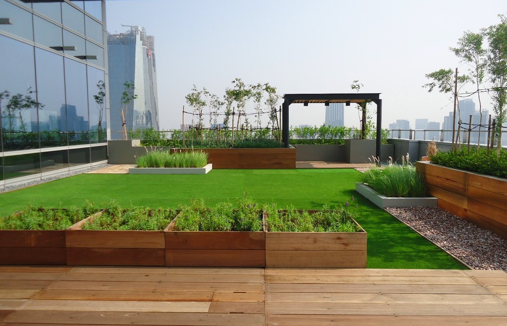 Cette image montre un jardin sur toit minimaliste de taille moyenne avec une exposition ensoleillée et une terrasse en bois.