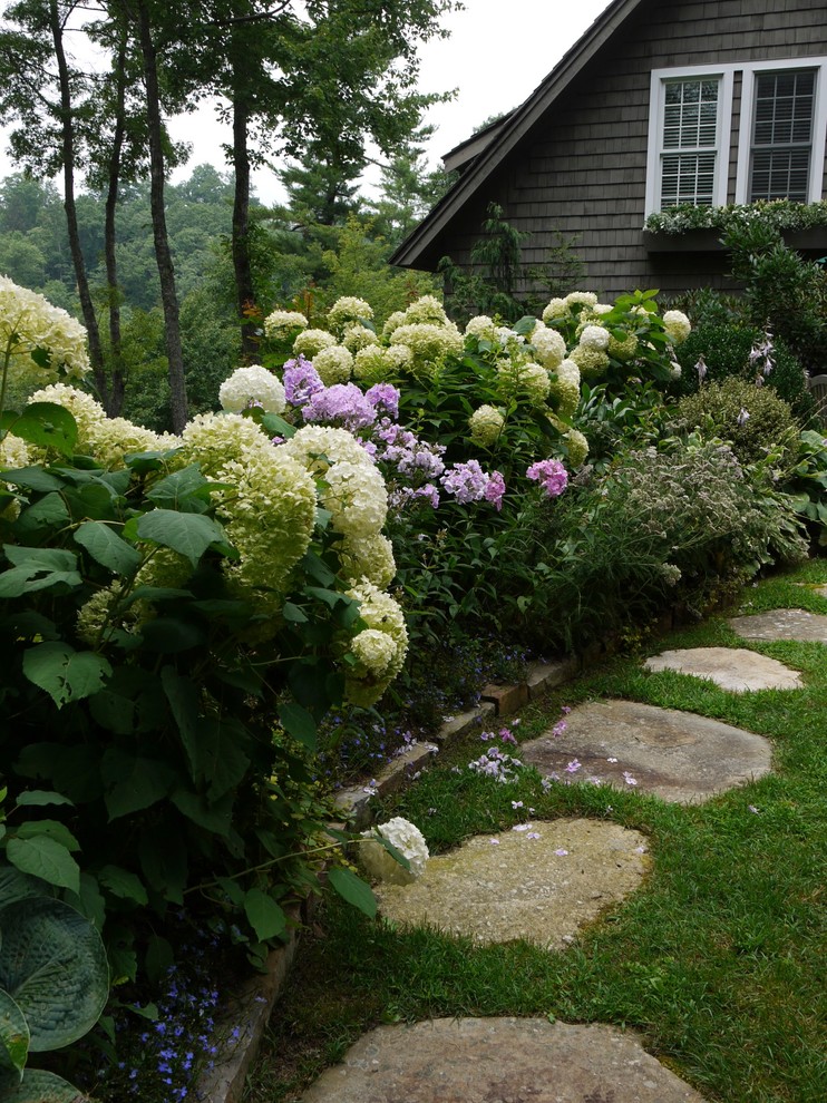 Design ideas for a traditional partial sun side yard stone garden path in Other.