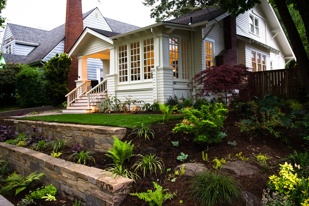 Inspiration for a craftsman front yard stone retaining wall landscape in Portland.