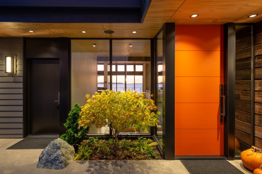 Medium sized modern courtyard xeriscape partial sun garden for summer in Seattle with a rockery and concrete paving.