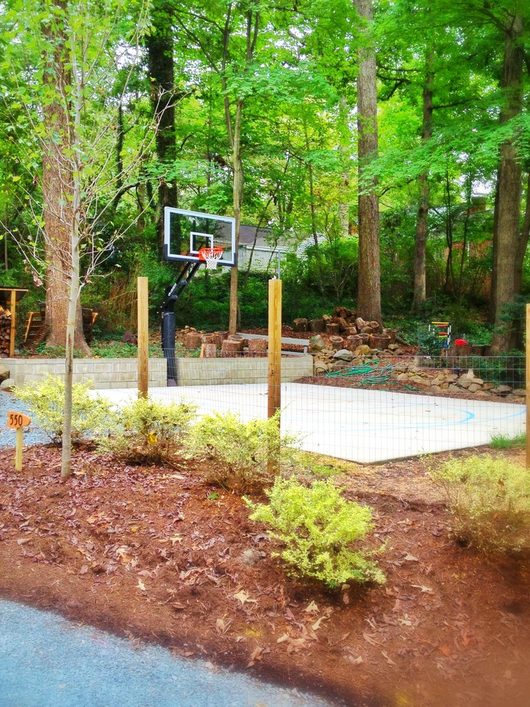 Design ideas for a large classic back partial sun garden in Raleigh with an outdoor sport court.