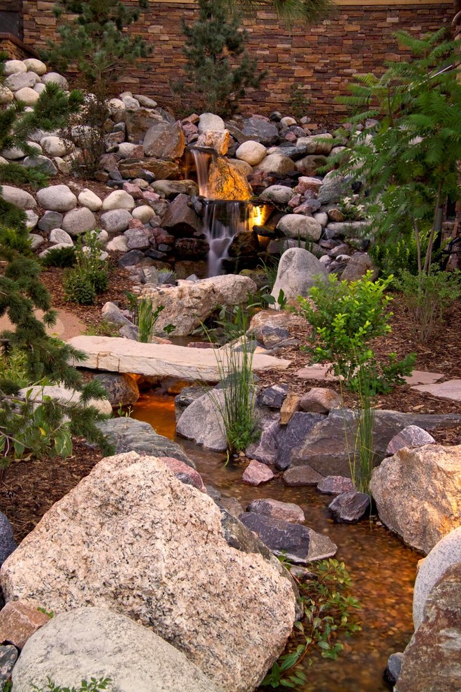 Design ideas for a rustic water fountain landscape in Denver.