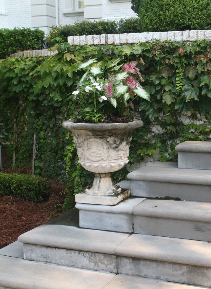 This is an example of a large traditional partial sun courtyard stone landscaping in Other.