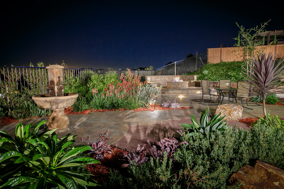 Design ideas for a large mediterranean drought-tolerant backyard concrete paver garden path in San Diego.