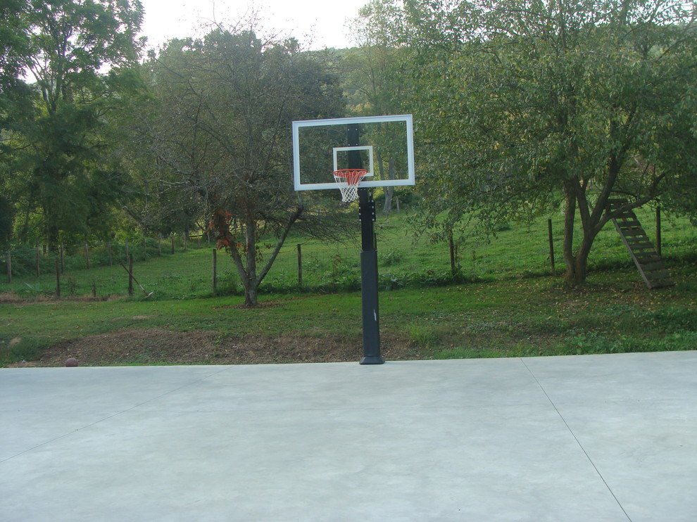 This is an example of a large classic back partial sun garden in Charleston with an outdoor sport court.